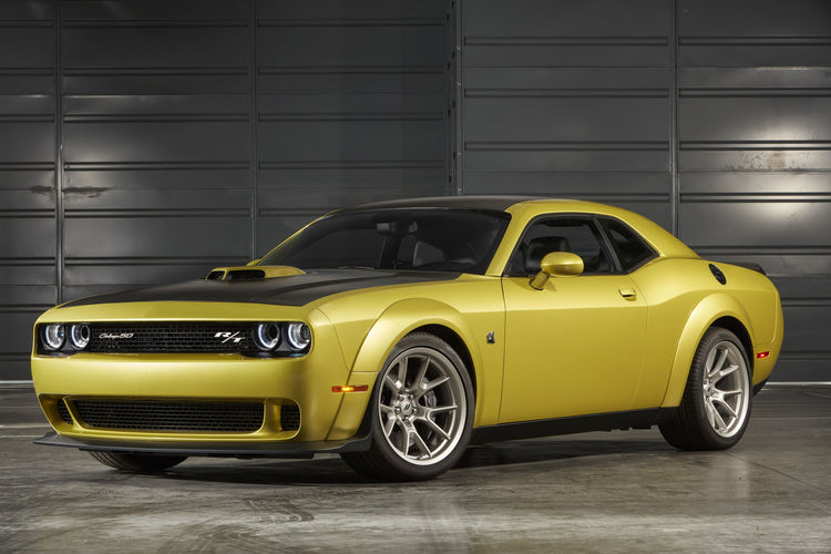 a yellow car parked in front of a garage door